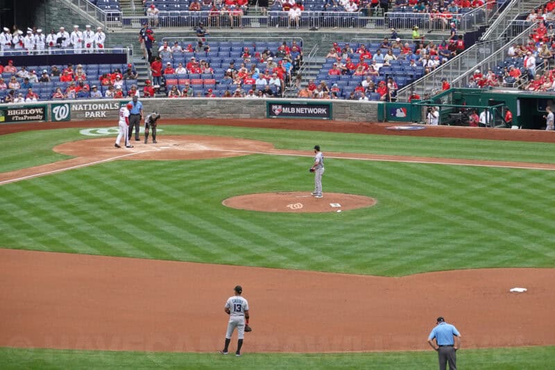 Baseball infield view with pitcher and batter captured at 200mm optical zoom