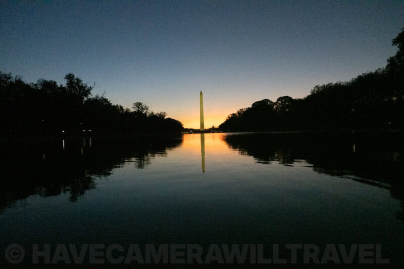 Washington Monument mirrored in the still Reflecting Pool beneath a dawn sky