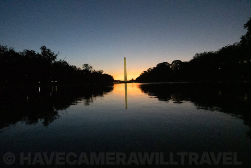 Washington Monument and its mirror image glowing over the Reflecting Pool at sunrise