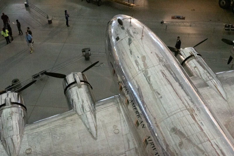 Aerial view of a vintage Pan American Airways propeller plane's polished metal fuselage and engines