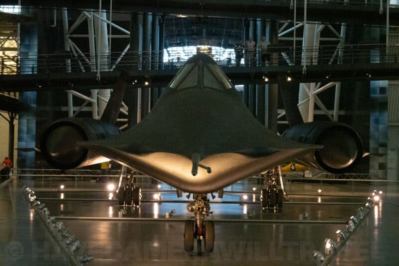 Rear view of the SR-71 Blackbird's twin engines and landing gear inside a museum hangar