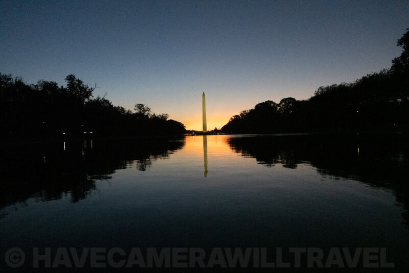 Washington Monument glowing at sunset with its reflection stretching across the Reflecting Pool