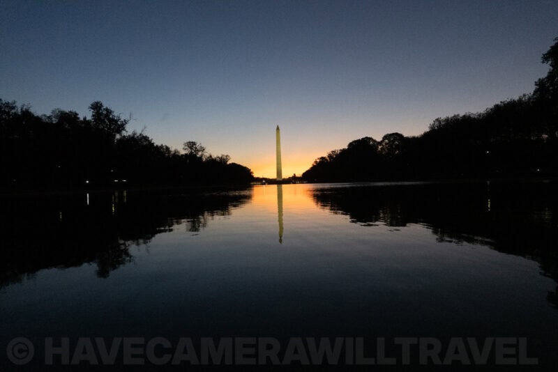 Washington Monument reflected in the Lincoln Memorial Reflecting Pool at dawn with orange horizon