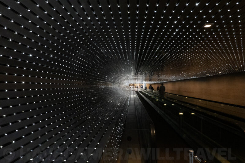 National Gallery of Art East Building concourse with sparkling light-tunnel ceiling installation and moving walkway