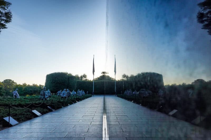 Korean War Veterans Memorial reflecting pool with statues mirrored in the black granite wall