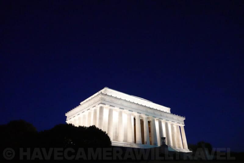 Lincoln Memorial illuminated white against a dark blue night sky