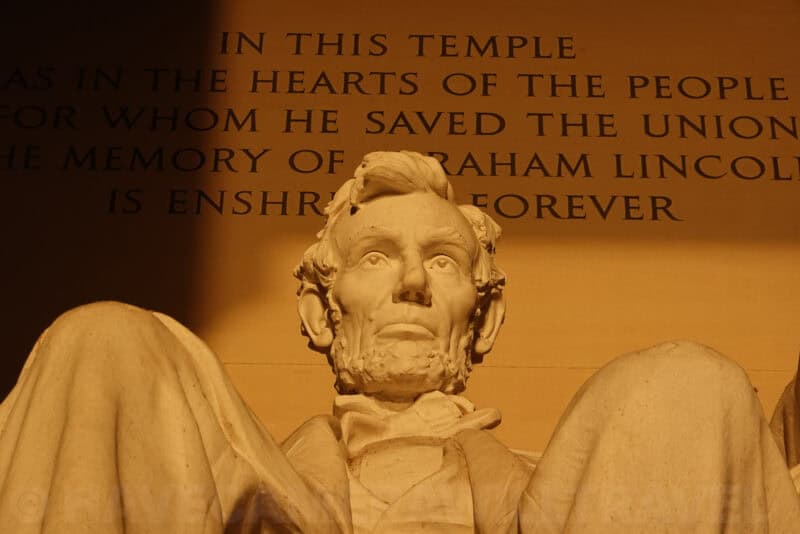 Close-up of the Lincoln Memorial statue's face lit in warm evening light