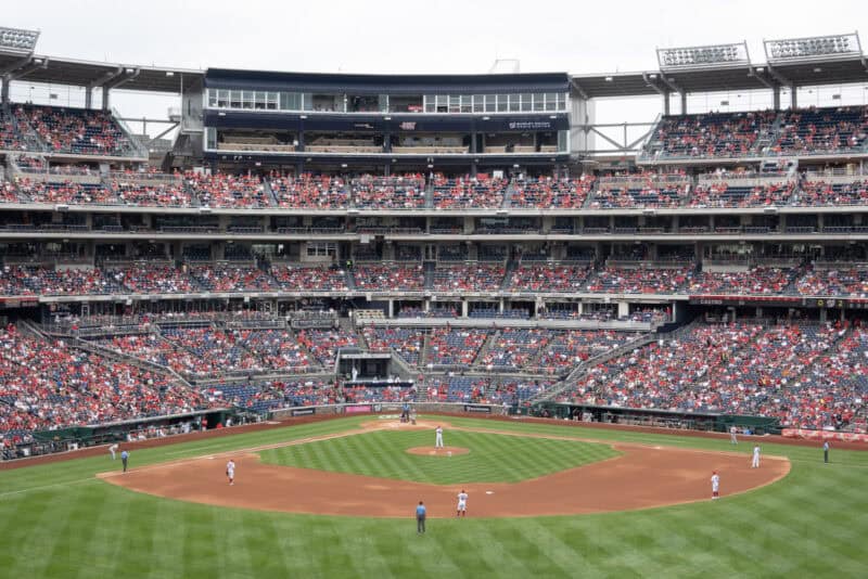 Baseball stadium filled with fans viewed from the outfield seating during a game