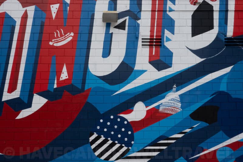 Colorful mural with bold lettering and a small Capitol dome illustration