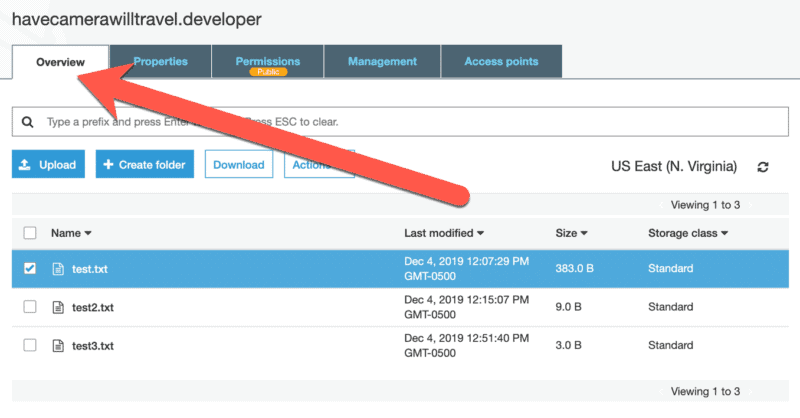 S3 bucket Overview tab listing uploaded text files with arrow pointing to the Overview tab