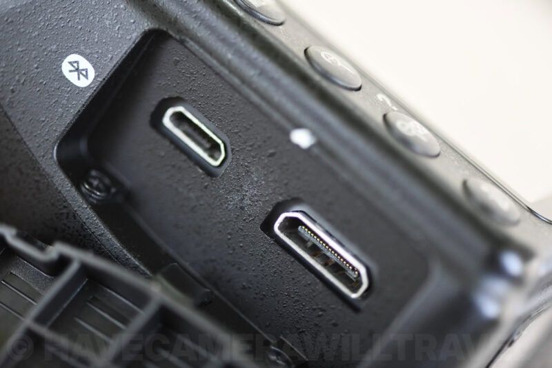 Close-up of a Nikon D3400's open port cover showing the micro-USB and HDMI connectors side by side