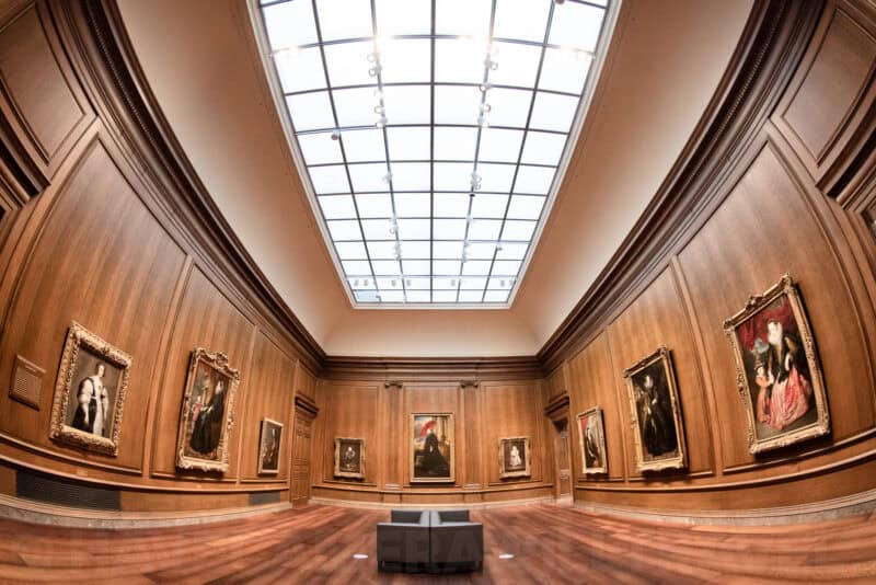 Wood-paneled portrait gallery with a long skylight at the National Gallery of Art