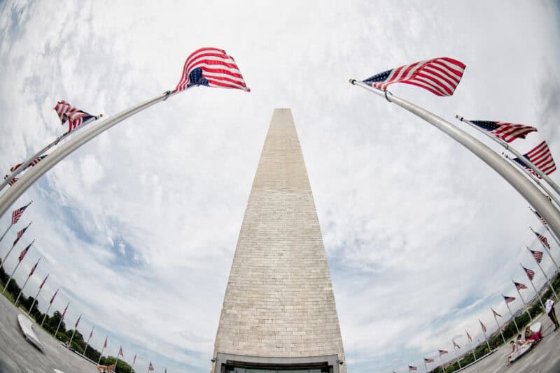 Washington Monument framed between two curved rows of American flags