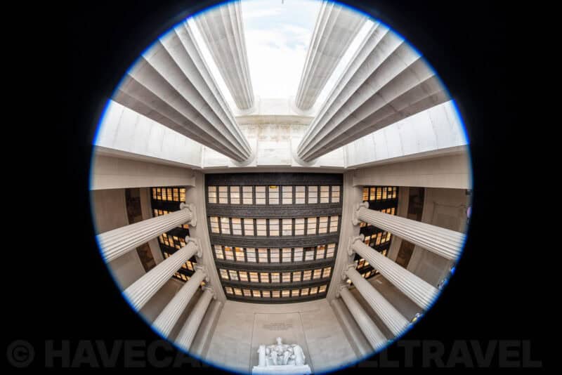 Circular fisheye view looking up at the Lincoln Memorial's colonnade and coffered ceiling beams