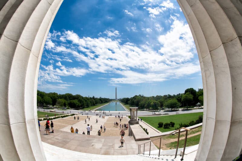View through an oval opening at the Lincoln Memorial overlooking the Reflecting Pool and Washington Monument