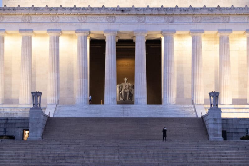 Lincoln Memorial facade with illuminated Doric columns and the seated Lincoln statue visible within
