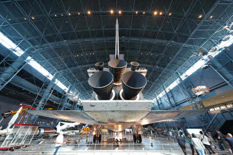 Rear view of a space shuttle's three main engines under a hangar's ribbed ceiling, ISO 100 sample photo