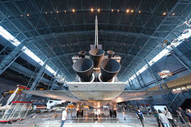 Underside of a space shuttle showing engine nozzles and tail in a museum hall, ISO 160 sample shot