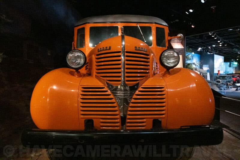 Orange antique truck's front grille and cab photographed at ISO 25600 in low museum light