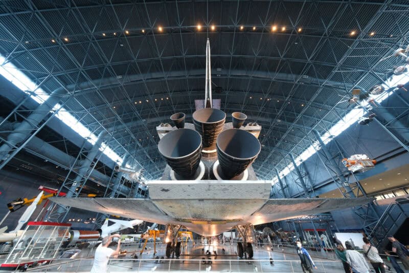 Space shuttle's rear engines and vertical stabilizer under a curved hangar roof, ISO 1000 sample shot