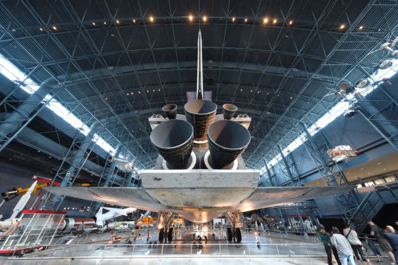 Space shuttle's rear engines and tail fin in the dim hangar, ISO 8000 test image with visible noise