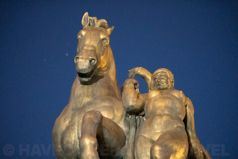 Close-up of the bronze equestrian statue atop Washington DC's Old Post Office building against a night sky