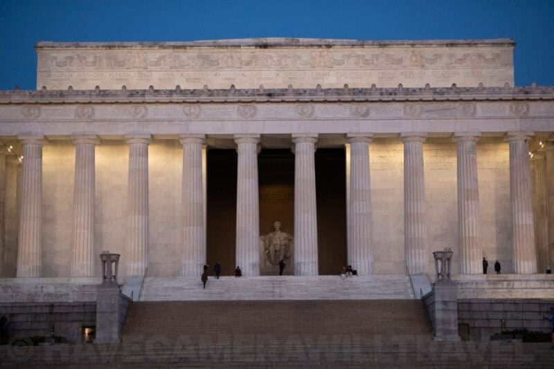 Lincoln Memorial in Washington DC lit up at dusk with its columned facade and statue visible inside