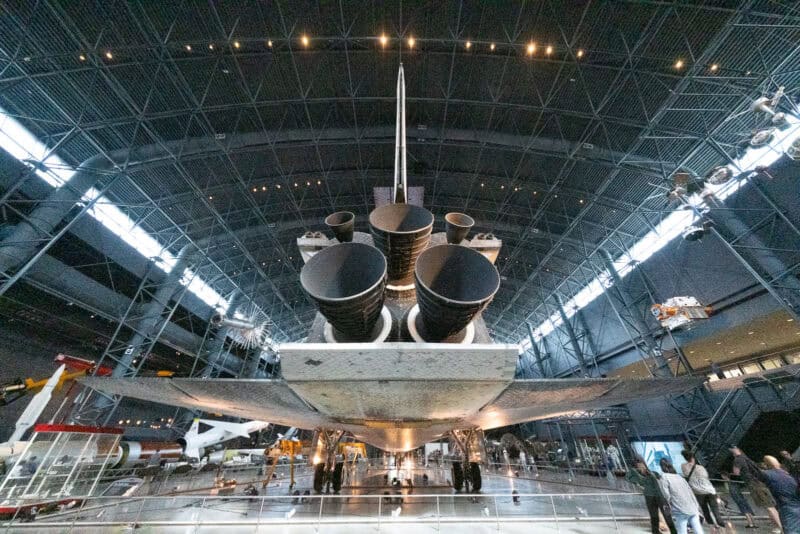 Space Shuttle Discovery's tail and engine nozzles seen from below inside the Udvar-Hazy Center hangar