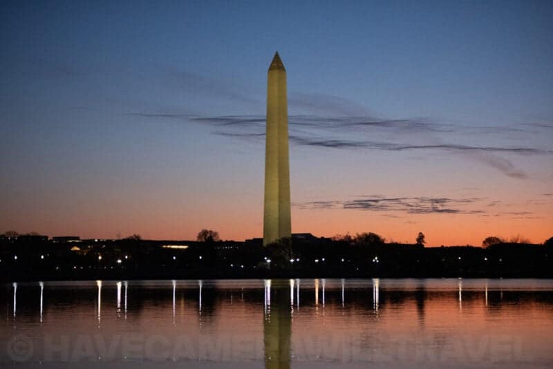 Washington Monument at dusk with soft clouds streaking across the sky above the Tidal Basin