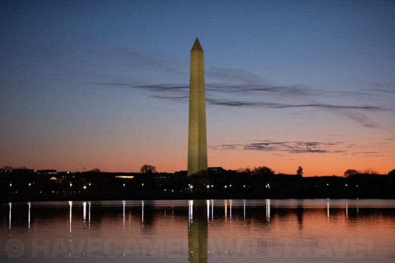 Washington Monument standing tall over the Tidal Basin as evening light fades