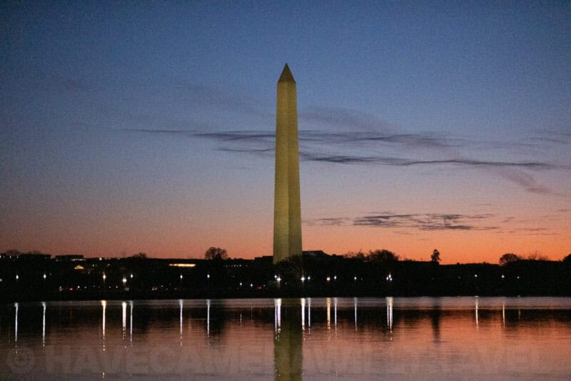 Washington Monument photographed in low light with visible grain and orange horizon band