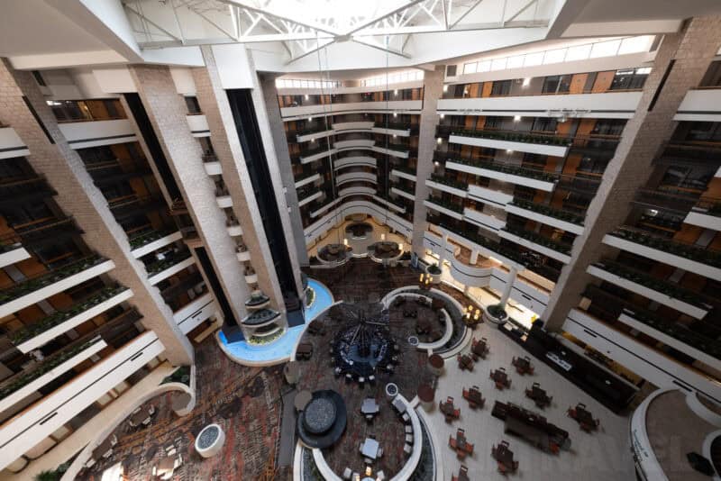 Overhead view of a hotel atrium lobby with balconied rooms and a central seating area