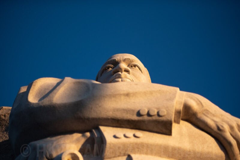 Martin Luther King Jr. Memorial statue face in profile against a clear blue sky