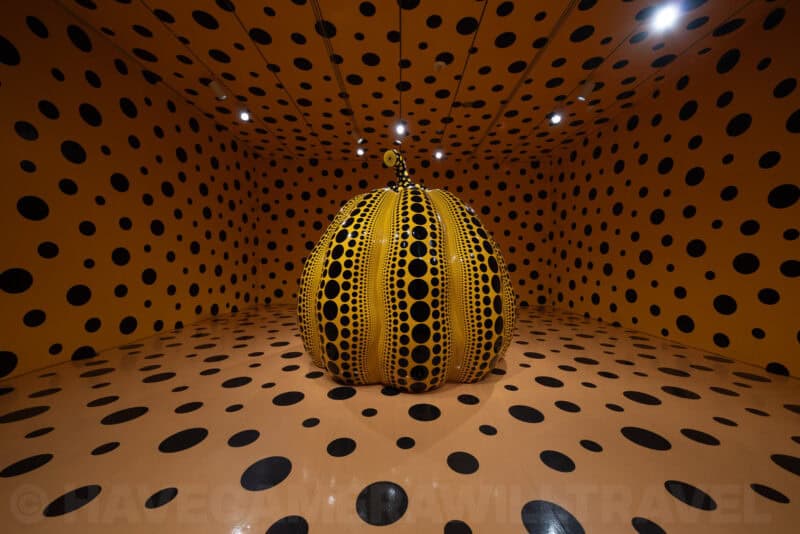 Yayoi Kusama polka-dot pumpkin sculpture inside a mirrored, dot-covered infinity room