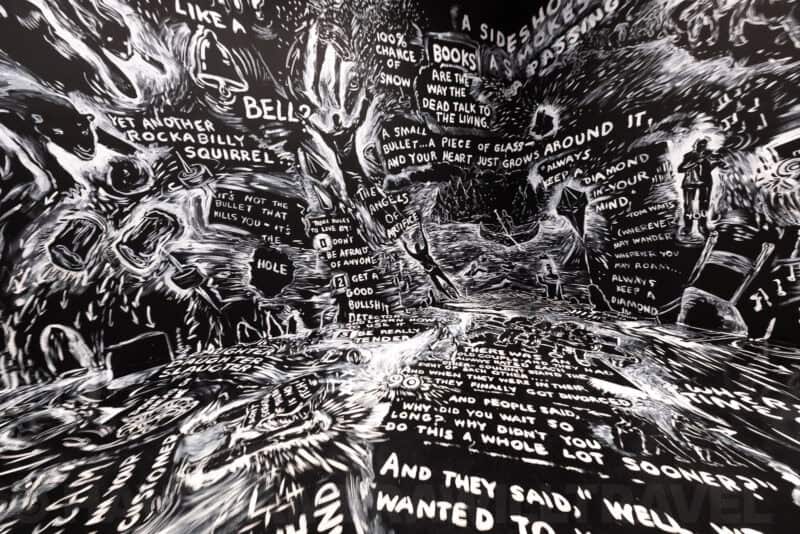 Immersive black-and-white illustrated exhibit covering the walls and floor at the Hirshhorn Museum
