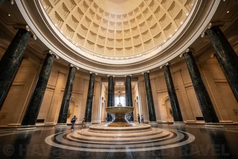 Domed rotunda with dark marble columns encircling a central fountain at the National Gallery of Art