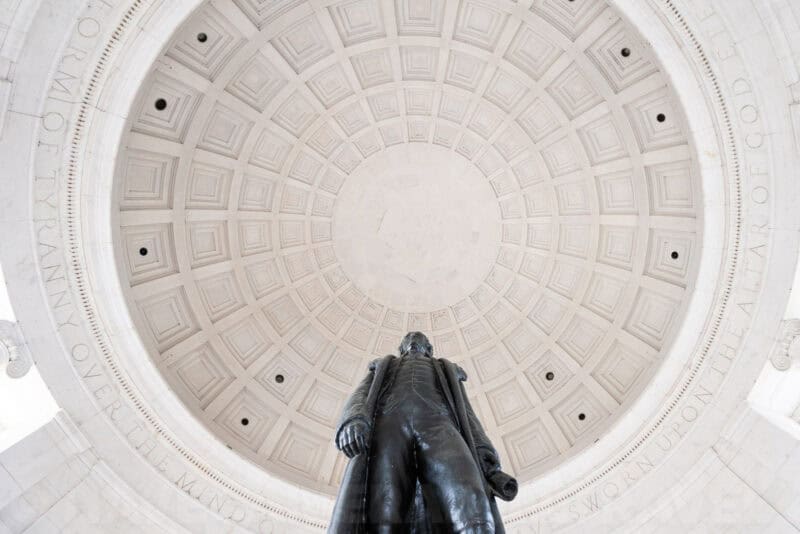 Upward view inside the Jefferson Memorial dome above the bronze statue's head and shoulders