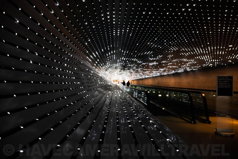 Illuminated tunnel installation with thousands of pinpoint lights radiating along a walkway