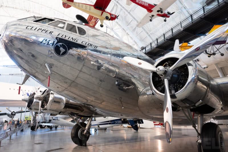 Polished aluminum Pan Am Clipper Flying Cloud seaplane nose and propeller inside an aircraft hangar museum