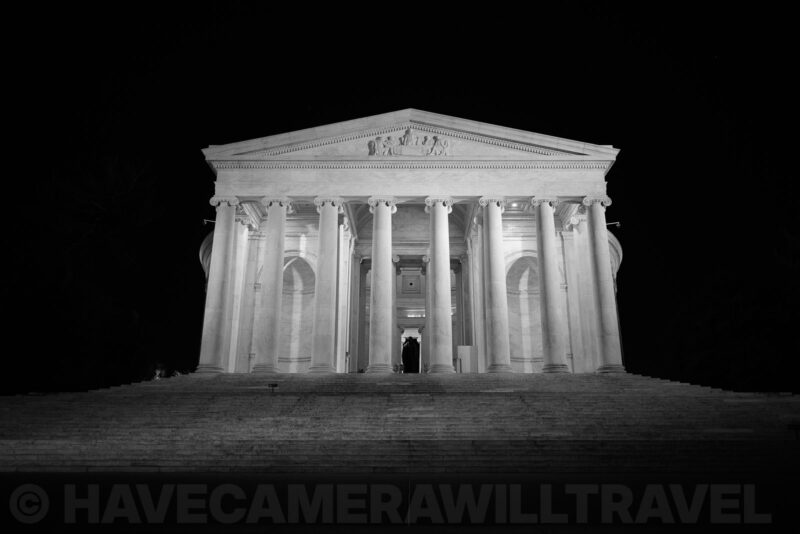 Jefferson Memorial illuminated at night, columns and pediment in black and white