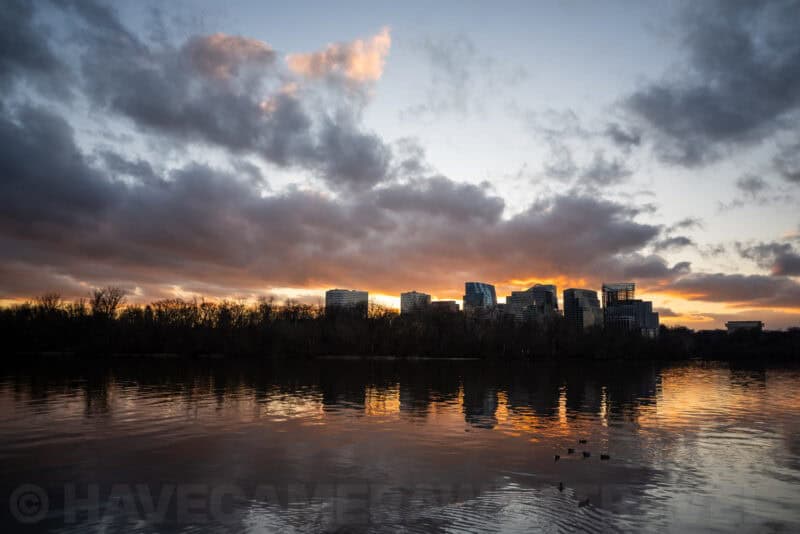 Rosslyn skyline silhouetted against a fiery sunset, reflected in the Potomac River