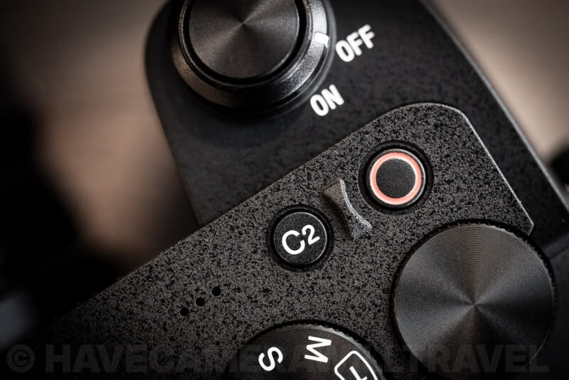 Close-up of the Sony a6700's top control dials, C2 button, and on/off switch