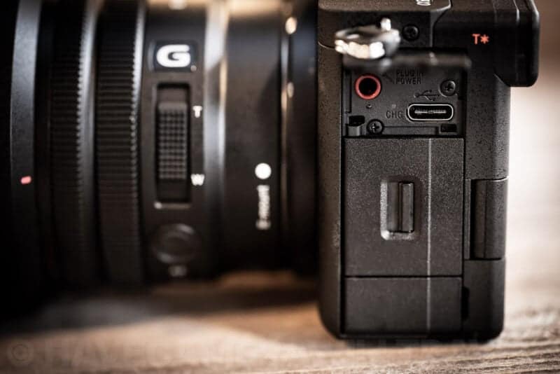 Side panel of the Sony a6700 showing the USB-C port, mic jack, and memory card slot