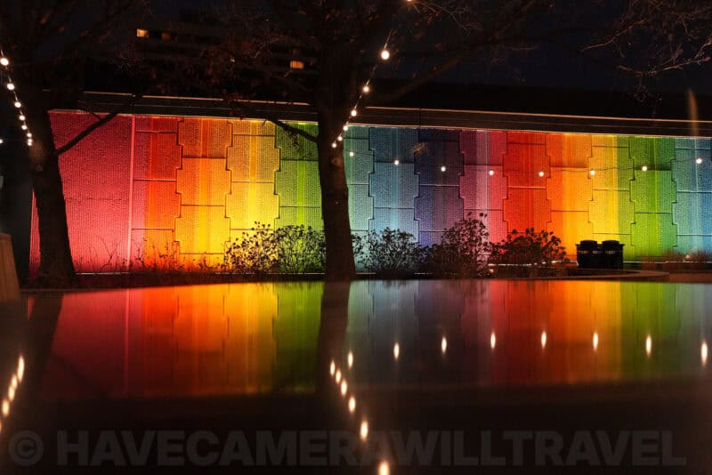 Night scene of rainbow-lit wall reflected in dark water, ISO 6400 sample shot