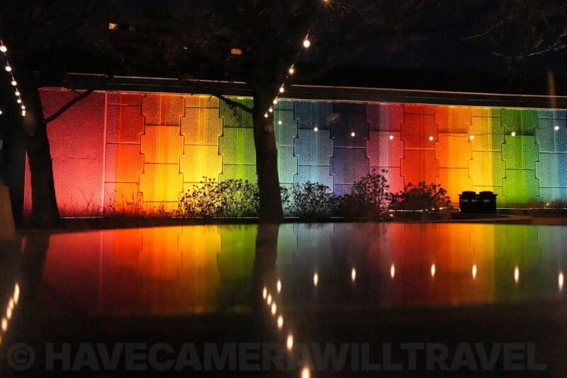 Rainbow-lit wall reflected in dark water showing noise at ISO 40000