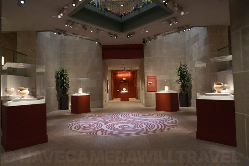 Museum hall with ceramic vases in glass cases and red pedestals, ISO 4000 test image