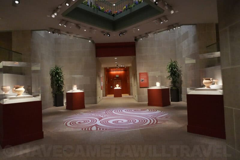Gallery interior with pottery exhibits and patterned floor rug, ISO 5000 noise test