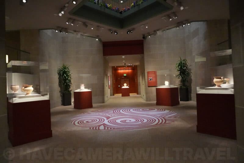 Museum hallway with pottery cases and red pedestals, ISO 10000 high-ISO sample