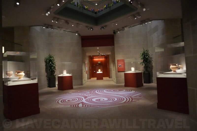 Gallery with ceramic artifacts on display and patterned floor, ISO 12800 noise test