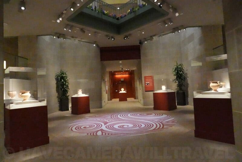 Low-light museum hallway with pottery exhibits, ISO 40000 high-ISO sample